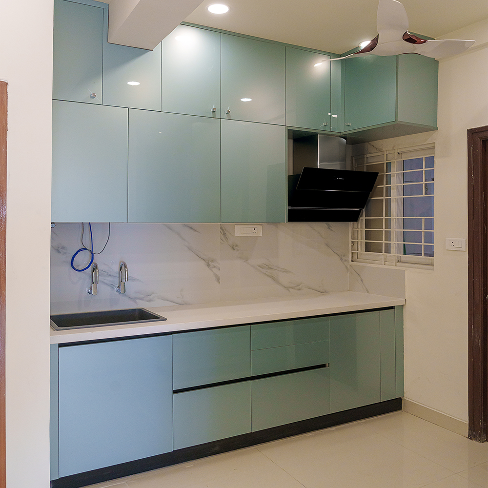 Minimal Open Kitchen Design With Marble Counter and Blue Units Livspace