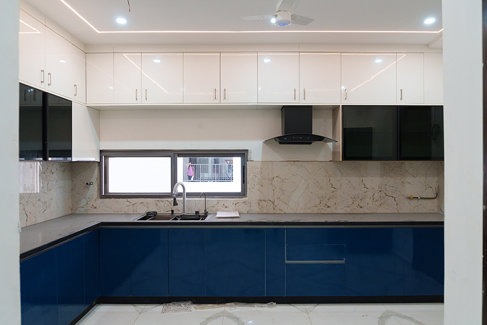 Modern L-Shaped Kitchen Design With Blue Cabinets and Marble Top | Livspace