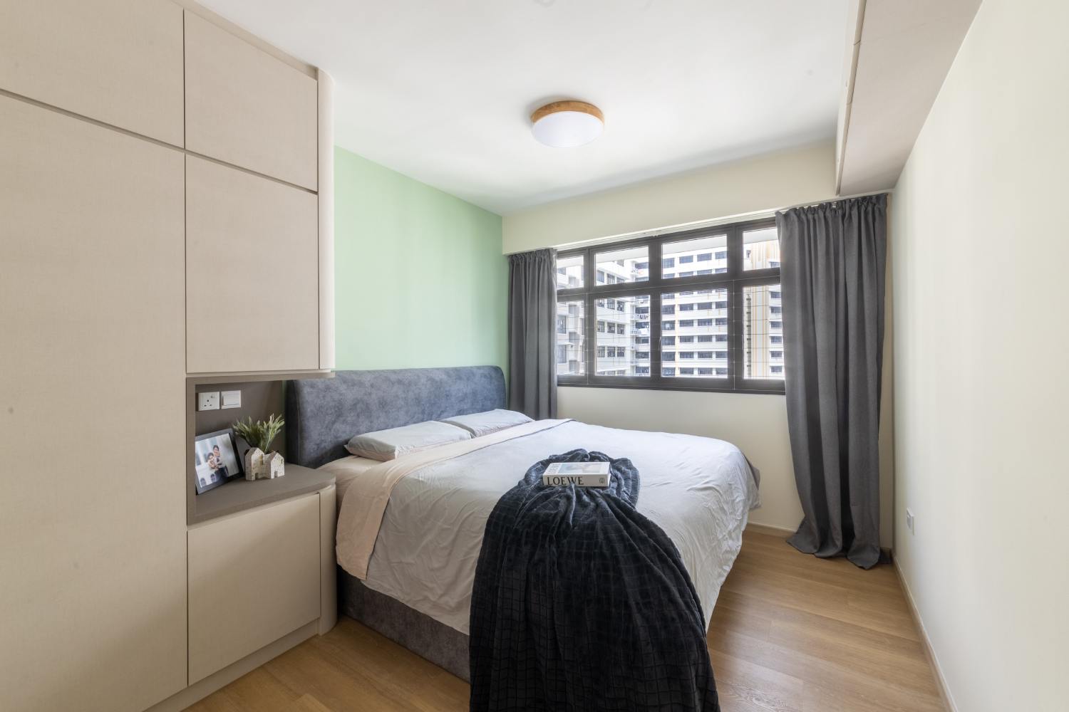 Spacious Master Bedroom with Tufted Grey Bed | Livspace