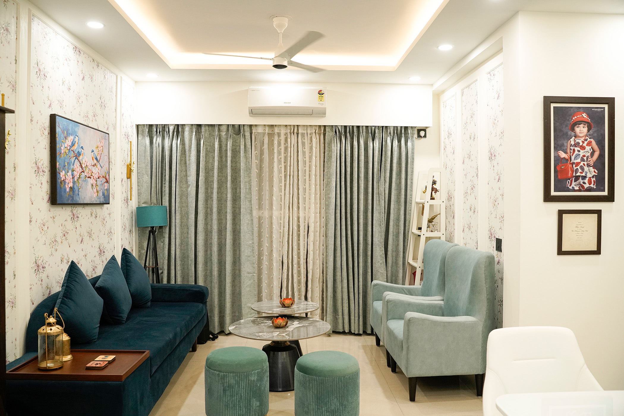 Contemporary Living Room Design with Teal Sofa and Marble Tables | Livspace
