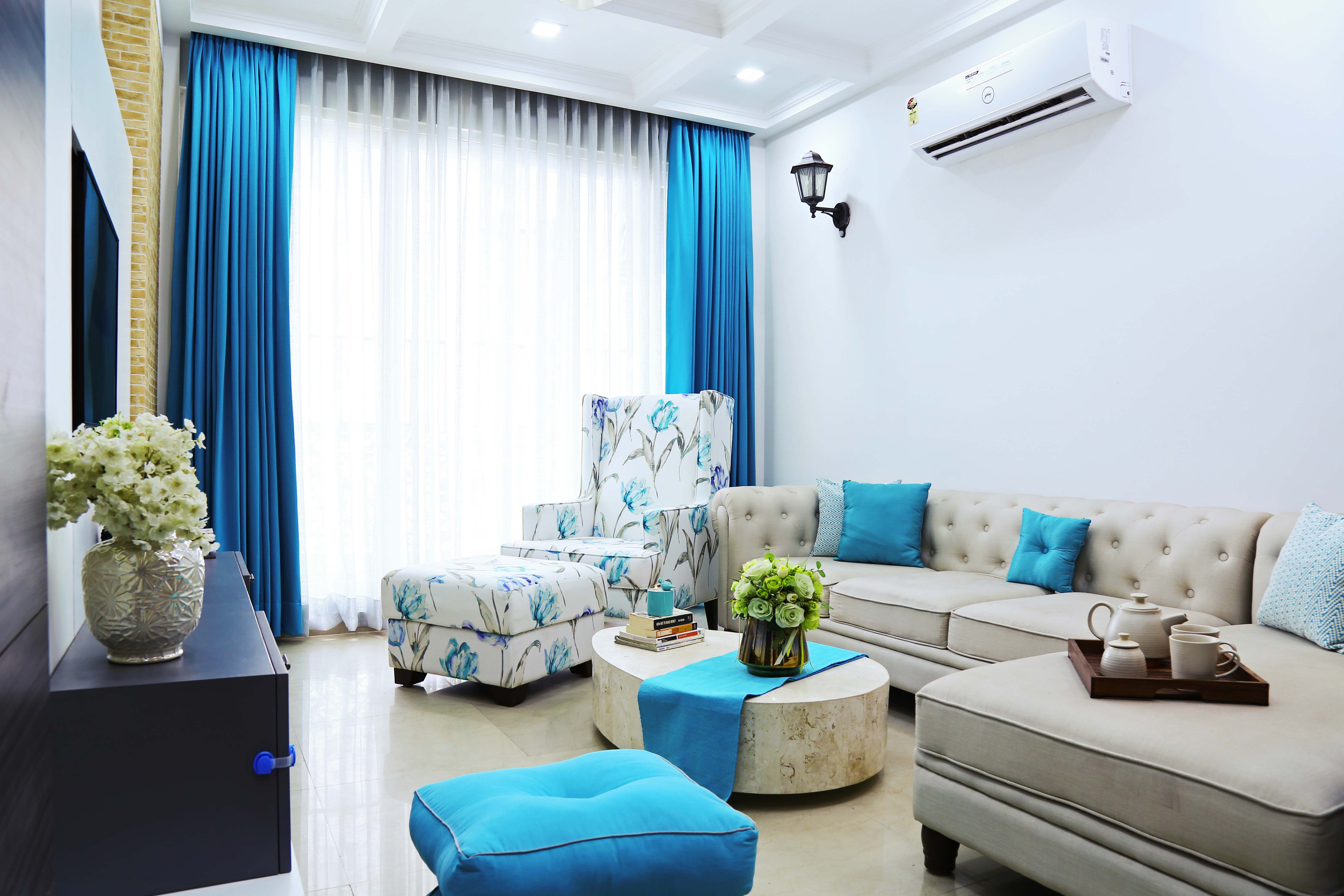 Beige Living Room Design With L-Shaped Sofa And White Floral Accent ...