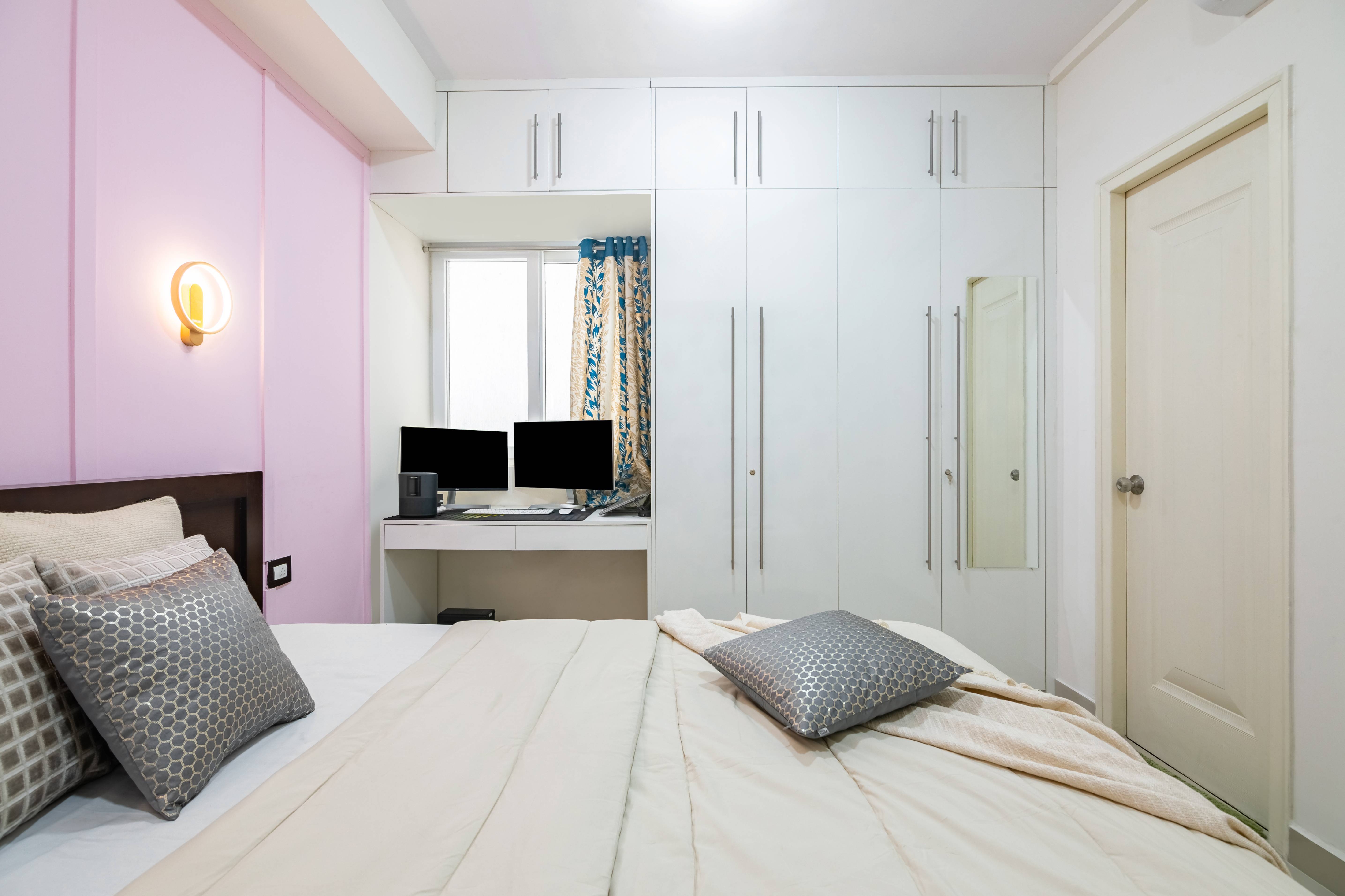 Spacious Guest Bedroom Design With Baby Pink Accent Wall And White