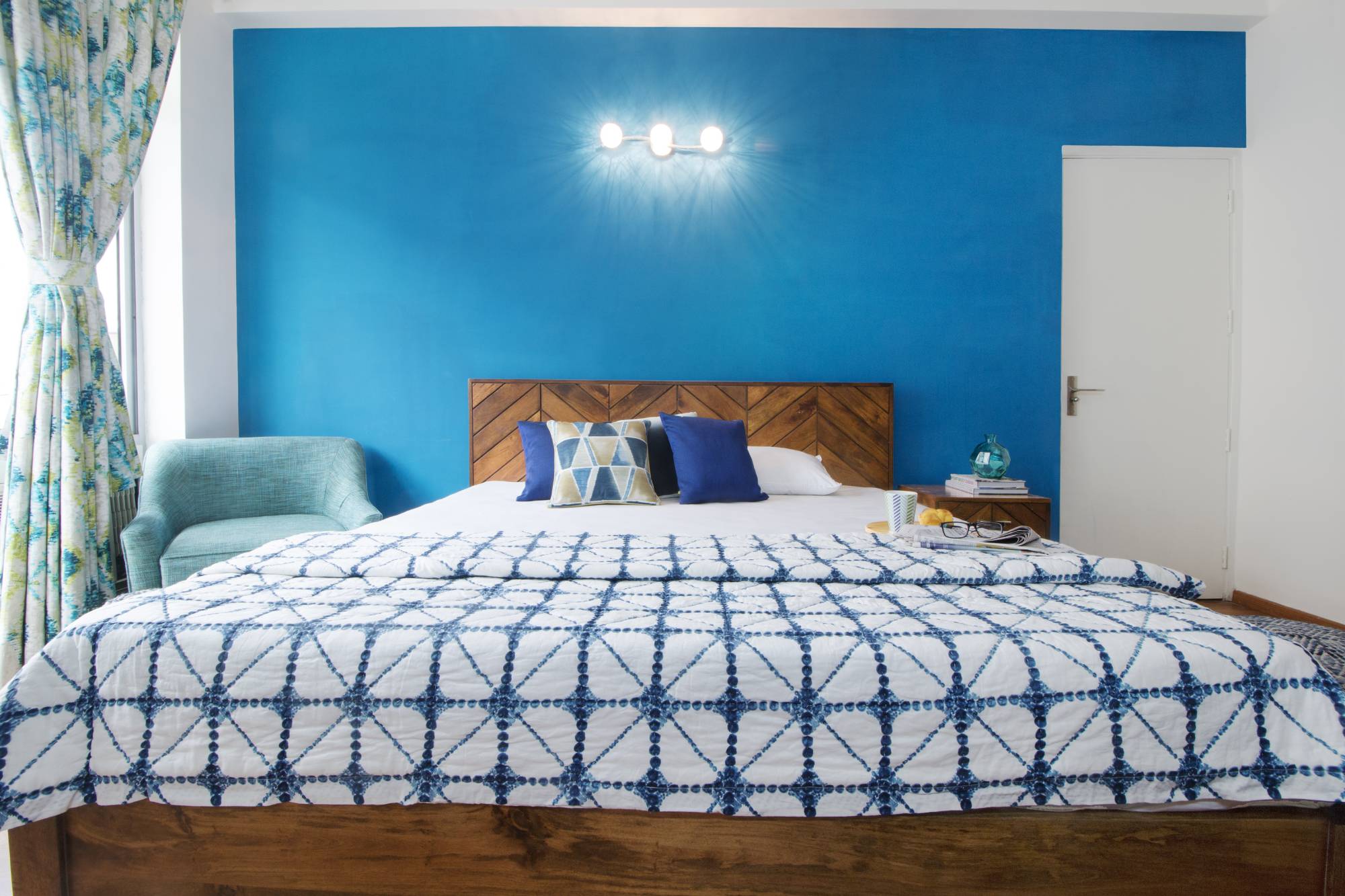 Kid's Bedroom Design With A Wooden Bed And Blue Accent Chair | Livspace