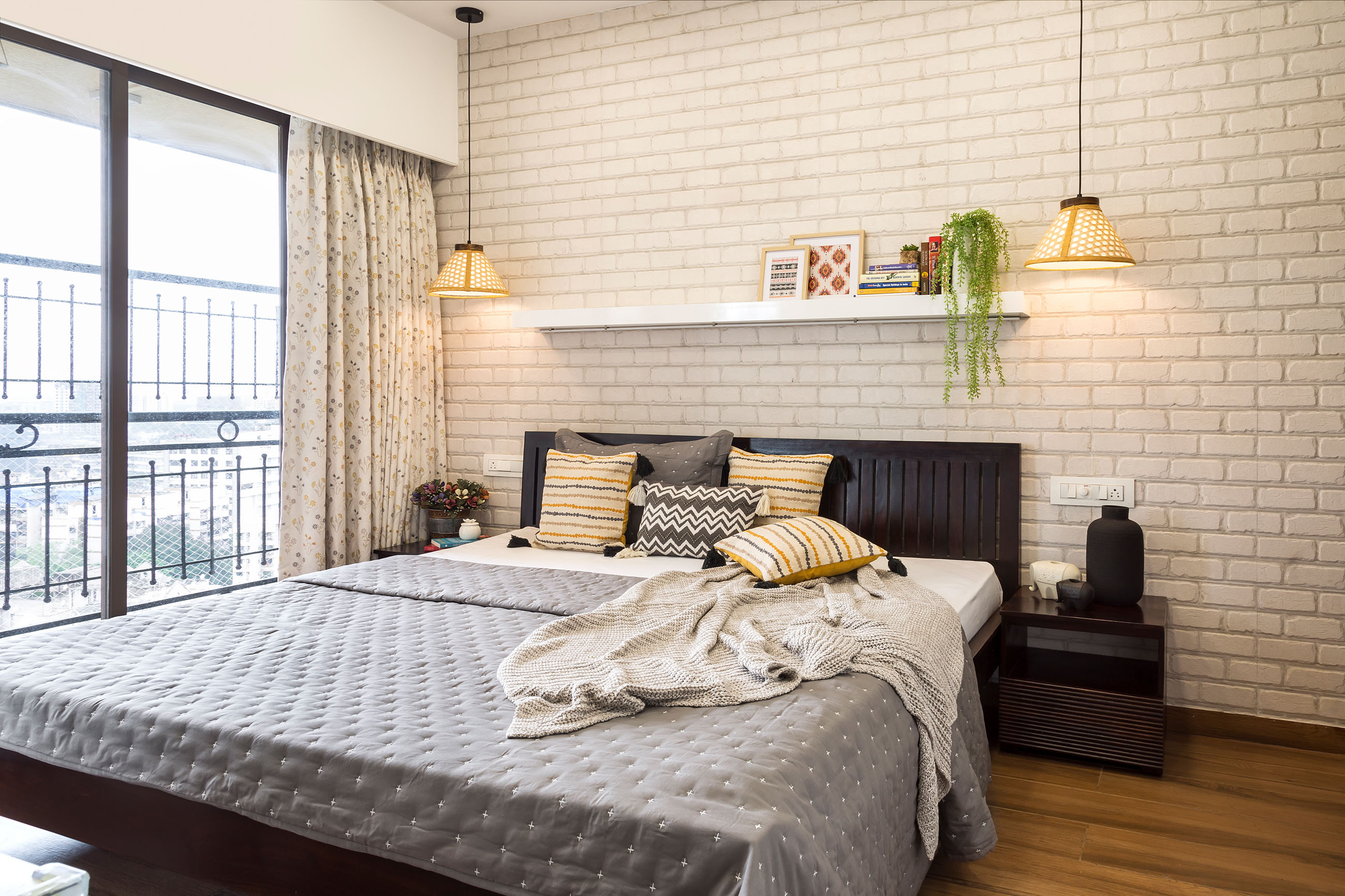 Compact Master Bedroom With White Brick Accent Wall And Wooden Bed ...