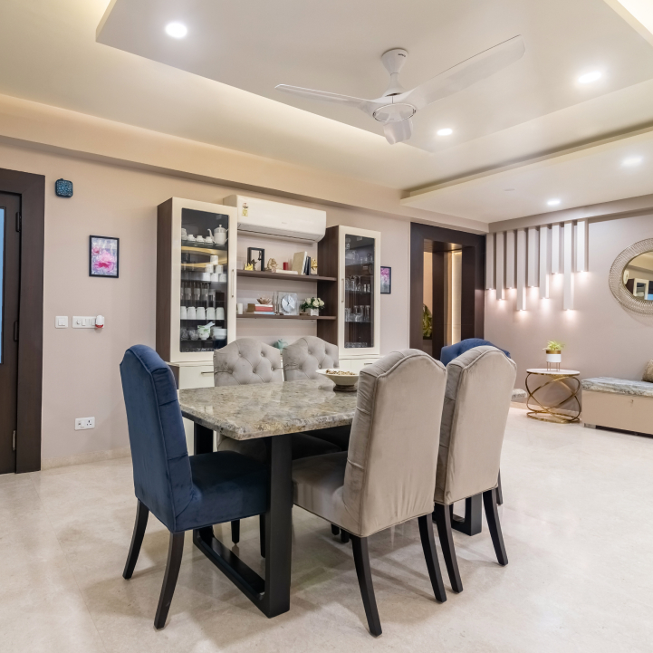 Spacious Dining Room With Fabric Upholstered Chairs | Livspace
